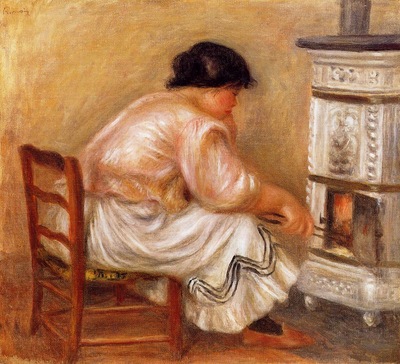 woman stoking a stove