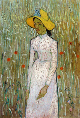 young girl standing against a background of wheat